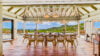 Luxury villa pool terrace in St Barts with loungers overlooking turquoise waters.