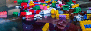 Child playing with colorful building blocks during a family villa vacation in St Barts.