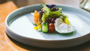 Gourmet dish at Villa 3H with fresh vegetables and poached egg.