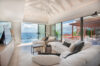 Bright living room in St Barts villa rental with panoramic sea views and terrace access