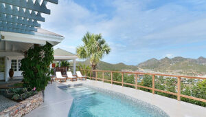 Hilltop villa with private pool, lounge chairs, and scenic views of mountains and valleys in St. Jean