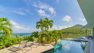 Pool terrace with loungers and ocean view, Lorient, St. Barts.