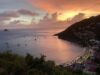 Sunset over Gustavia harbor with anchored sailboats and hillside view at St Barthelemy vacation rental.