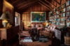 Cozy library lounge in St Barts villa with bookshelves and wood interiors.