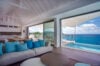 Open-concept St Barts villa with oceanfront living room, pool terrace, and panoramic island views.