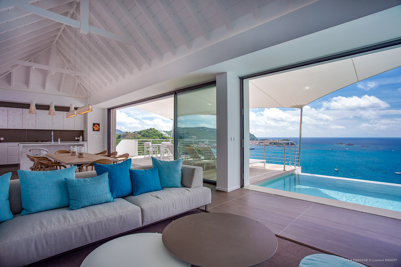 Open-concept St Barts villa with oceanfront living room, pool terrace, and panoramic island views.