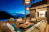 Elegant villa terrace with candlelit lounge seating, infinity pool, and twilight ocean views in St Barts luxury rental