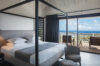 Bedroom in St Barts villa with four-poster bed and terrace ocean view.