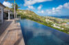 Infinity pool at St Barts villa with hillside and ocean views.
