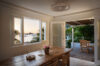 Elegant dining area in a St Barts villa with sunset views over the harbor and terrace seating