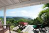 Terrace with sun loungers and panoramic ocean views at a hillside St Barts villa rental