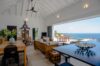 Open-plan living and dining room with ocean view terrace at St Barts luxury villa rental.