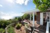 Clifftop terrace with ocean views and sun loungers at a private St Barts villa rental
