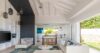 Open-plan living room in St Barts villa with sofas and modern kitchen.