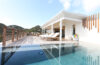 Deck with sun loungers beside pool and hillside view at St Barts luxury villa rental