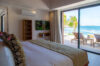 Seaside bedroom with ocean views and terrace access inside beachfront villa rental in St Barthélemy.
