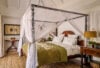 Romantic bedroom in st barts villa with four-poster canopy bed and island-inspired decor.