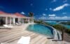 Sunlit infinity pool and teak terrace overlooking turquoise bays at luxury villa rental in St Barts