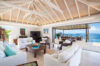Bright open living room in luxury st barts villa with ocean view terrace and vaulted ceiling.