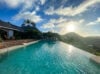 Heated infinity pool at villa chanticleer st barths overlooking Lorient Bay and tropical hills at sunset.