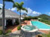 Terrace with heated pool and jacuzzi at villa chanticleer st barts surrounded by tropical gardens and hillside views