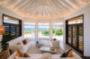Bright living room with vaulted ceiling, panoramic ocean views, and contemporary décor at a luxury villa in St Barts
