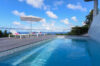 Infinity-edge pool at luxury st barts villa overlooking the Caribbean Sea under blue sky.