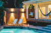Evening poolside terrace with hammock, deck chairs, and warm lighting at luxury villa rental in St Barths