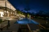 Luxury villa terrace with illuminated pool and ocean views at night in St Barts