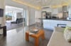 Modern open kitchen and living area with terrace access at Villa Plumbago, st barts villa rental