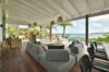 Open-air lounge with ocean views and modern seating at a private St Barts villa rental