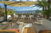 Sun deck with loungers, parasol, and ocean view at a luxury St Barts villa rental