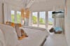 Bright bedroom with sea view and natural décor details at private villa rental in St Barthélemy