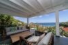 Shaded terrace with modern lounge seating and ocean view at a private villa rental in St Barts.