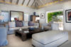 Bright living room in st barts villa with modern decor and garden view terrace.