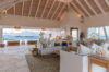 Elegant open-air living room with ocean view and vaulted ceiling, luxury villa rental in St Barts