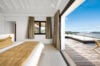 Bright bedroom with ocean view terrace and modern design at a luxury villa rental in St Barts