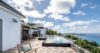 Luxury villa terrace with dual infinity pools overlooking the Caribbean Sea and islands of St Barts