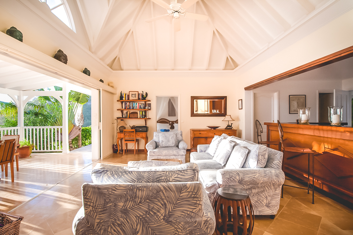 Bright living room with vaulted ceiling and terrace access at luxury villa rental in St Barths