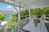 Shaded outdoor dining terrace with sea view at vacation rental St Barts surrounded by tropical greenery