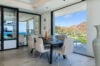 Modern dining room with mountain and sea views inside private villa rental in St Barts