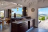 Open kitchen and dining space in luxury st barts villa with ocean view and natural light.