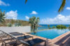 Infinity pool with sun loungers and ocean view under clear blue sky at Villa Plumbago, st barts villa rental