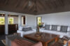 Elegant living room with high wooden ceilings and neutral décor, luxury villa rental in St Barts