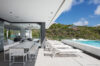 Sleek pool terrace with sun loungers and alfresco dining area at a St Barths luxury villa rental.