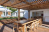 Outdoor dining terrace with wooden pergola and sun loungers, private villa rental in St Barts