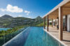 Infinity pool overlooking green hills and ocean, luxury villa rental in St Barts