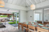 Elegant dining room with wooden table and open terrace view, private villa rental in St Barts