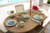 Outdoor dining table set with colorful ceramic plates beside the pool at st barth villa rental.