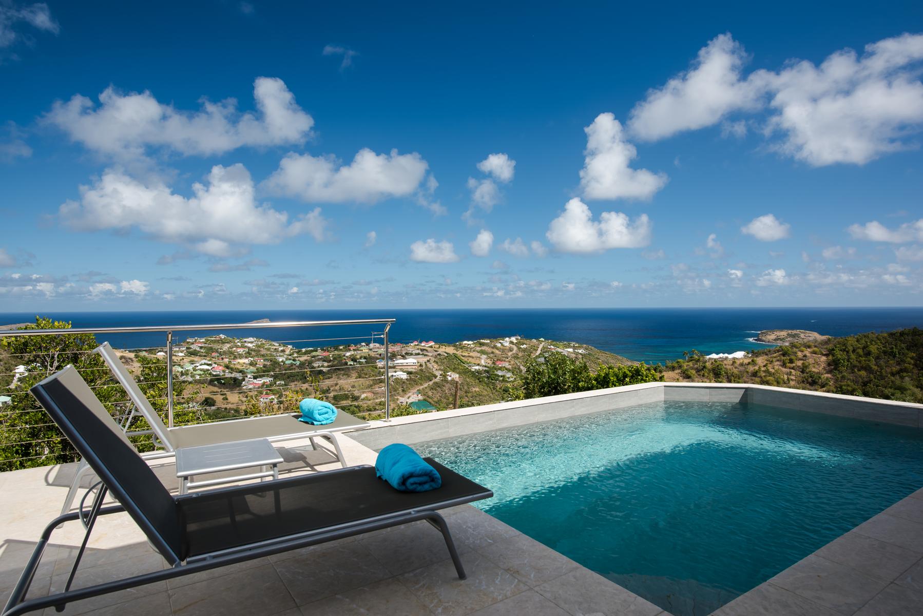 Infinity pool overlooking the Caribbean Sea and hillside views from a luxury villa in St Barts
